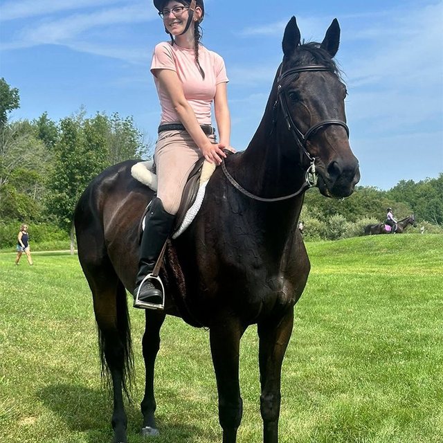 Original photo: a girl riding her dark bay horse in a field.